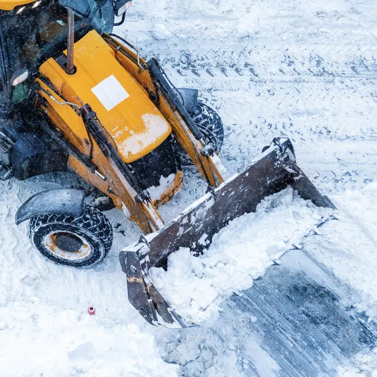 Winter maintenance tractor clearing snow from a road