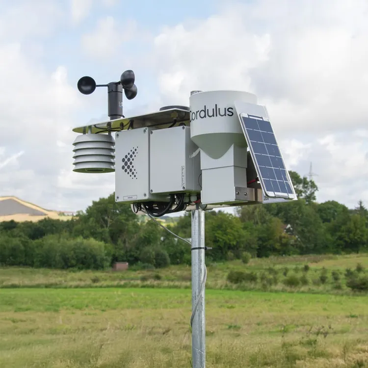 Cordulus weather station equipped with solar panel and wind speed sensor mounted on a metal pole in a grassy field.