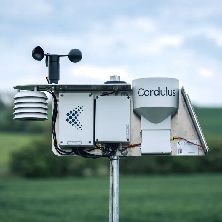 Cordulus weather station version two with anemometer and sensors on a pole in a green field.
