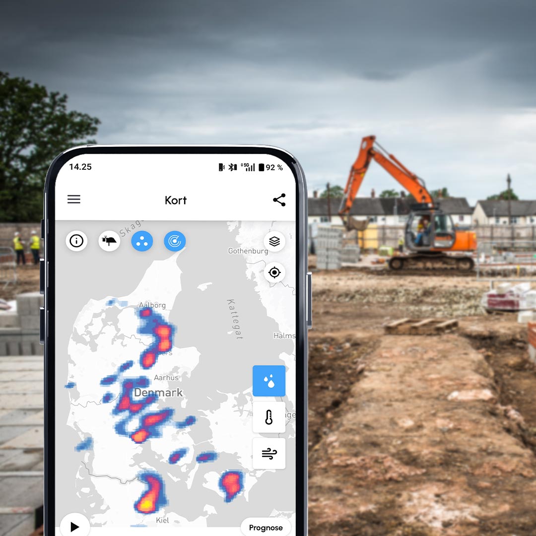 Cordulus Core App showing a weather map rain radar overlay in front of a construction site with an excavator.