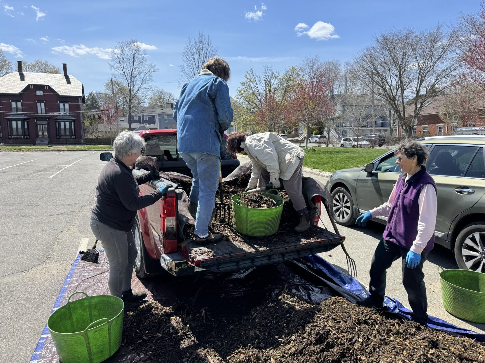 Members of the team behind the Pollinator Garden project prepare to transport mulch to the plot. PAULA ESTEY/Courtesy photo