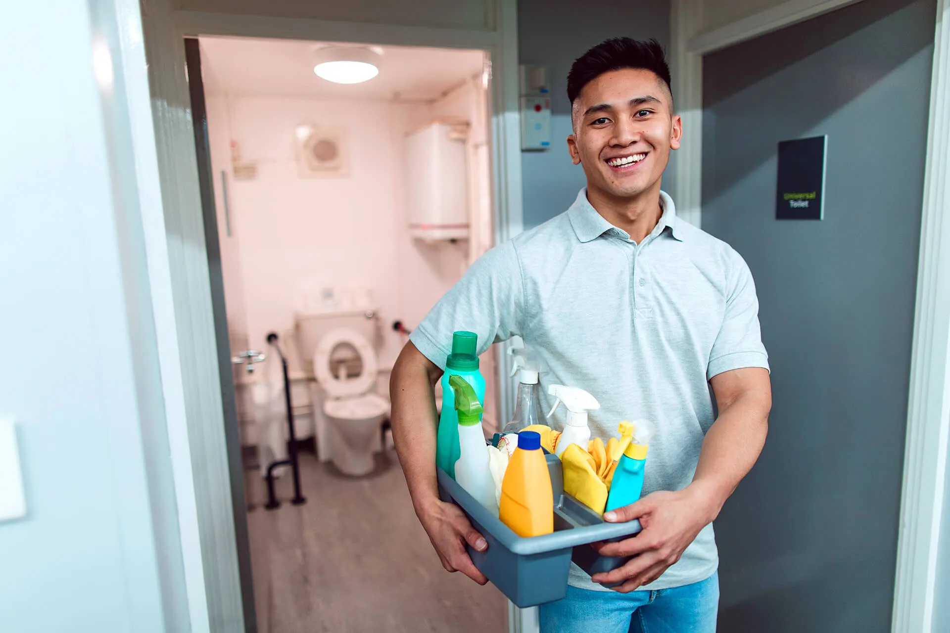 man holding cleaning supplies