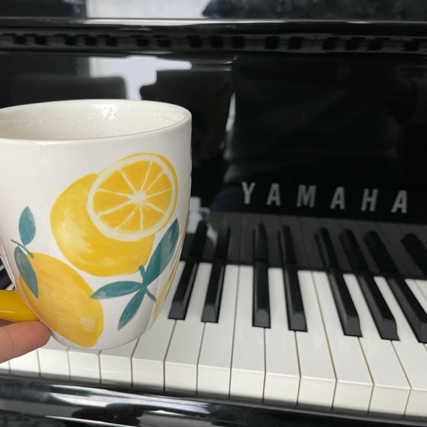 lemon mug on top of piano keys