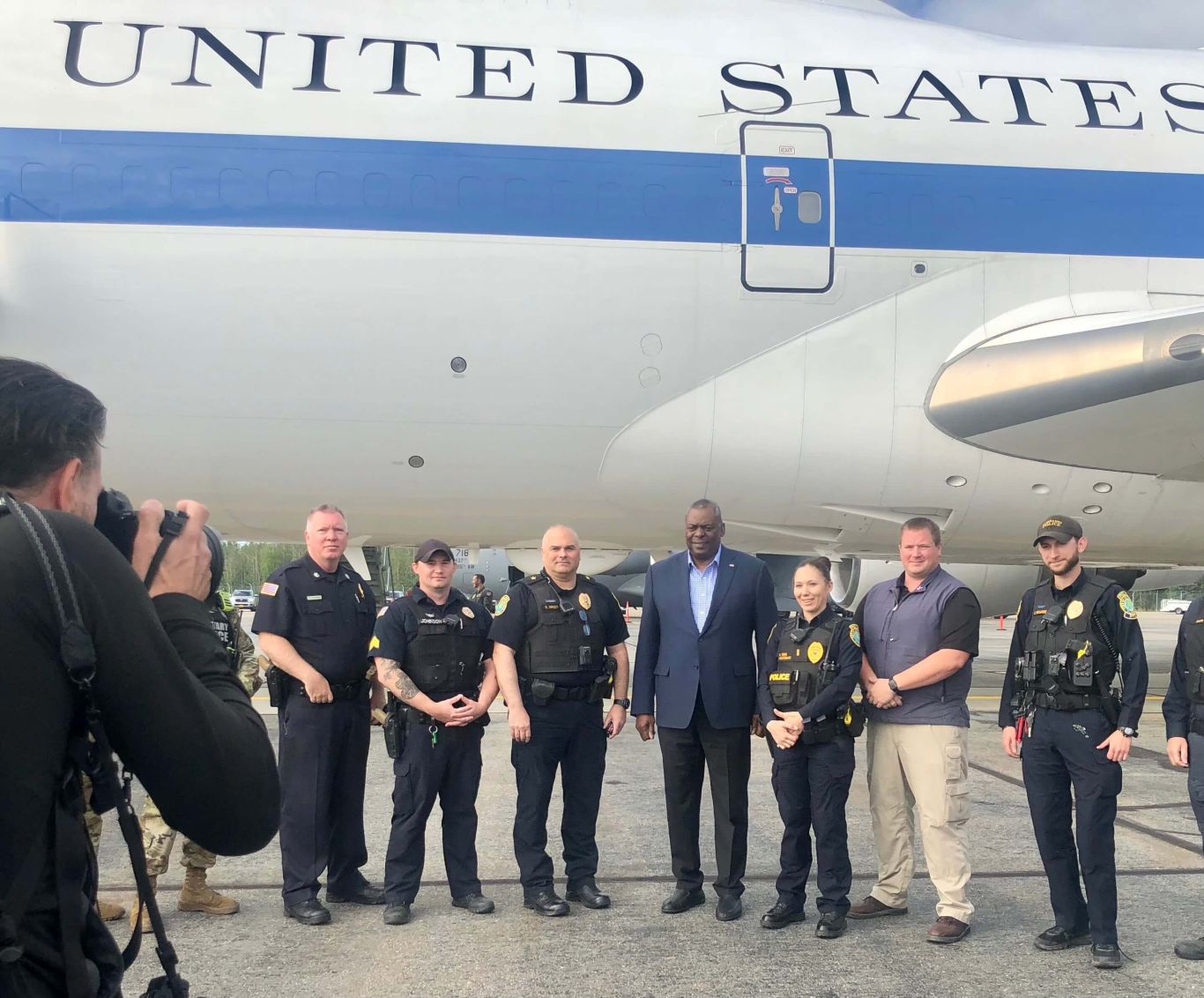 Police officers in front of airplane