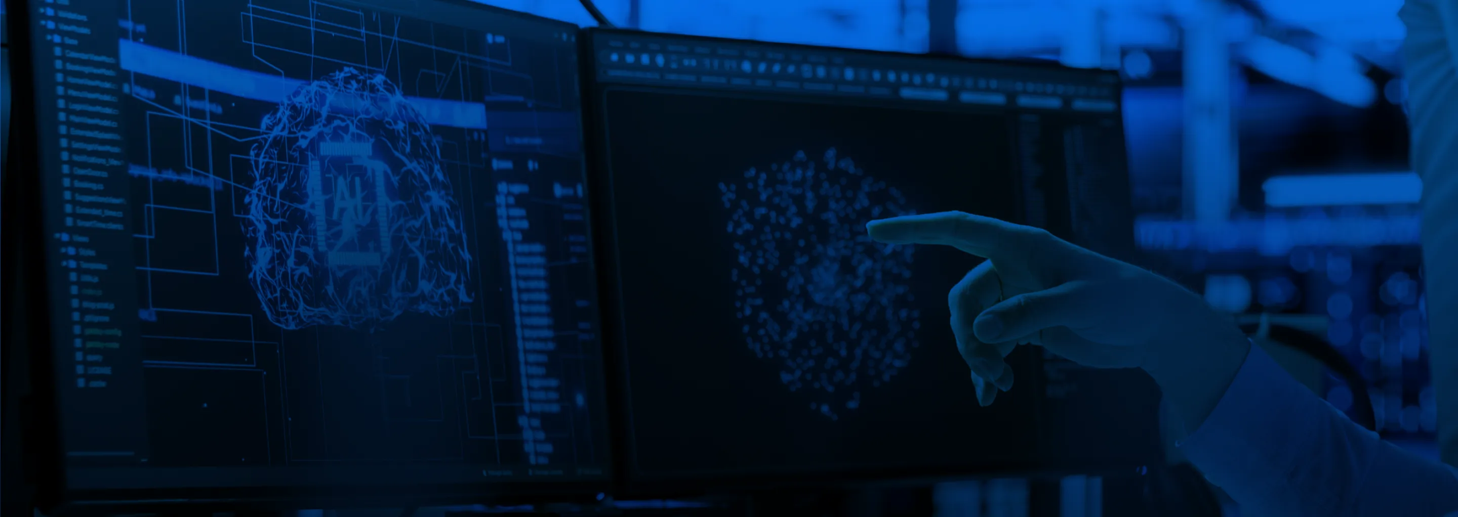Hand pointing at digital neural network and AI brain visualisations on two computer screens.
