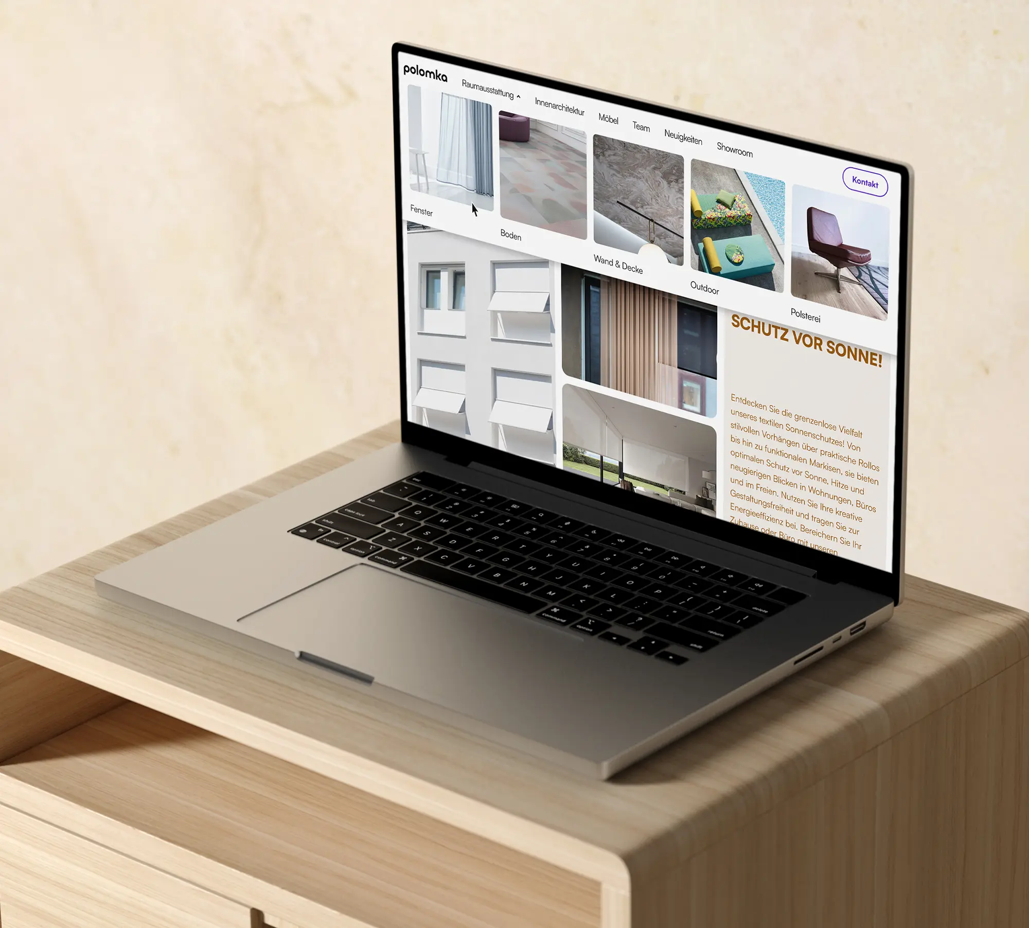 laptop with interior website standing on wooden desk