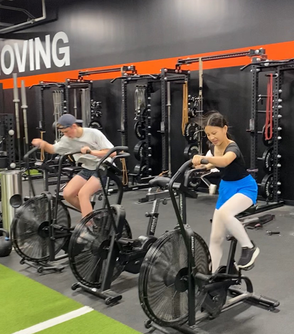 Clients training on the Assault Bikes with Coach Jason at the gym at The Crossover.