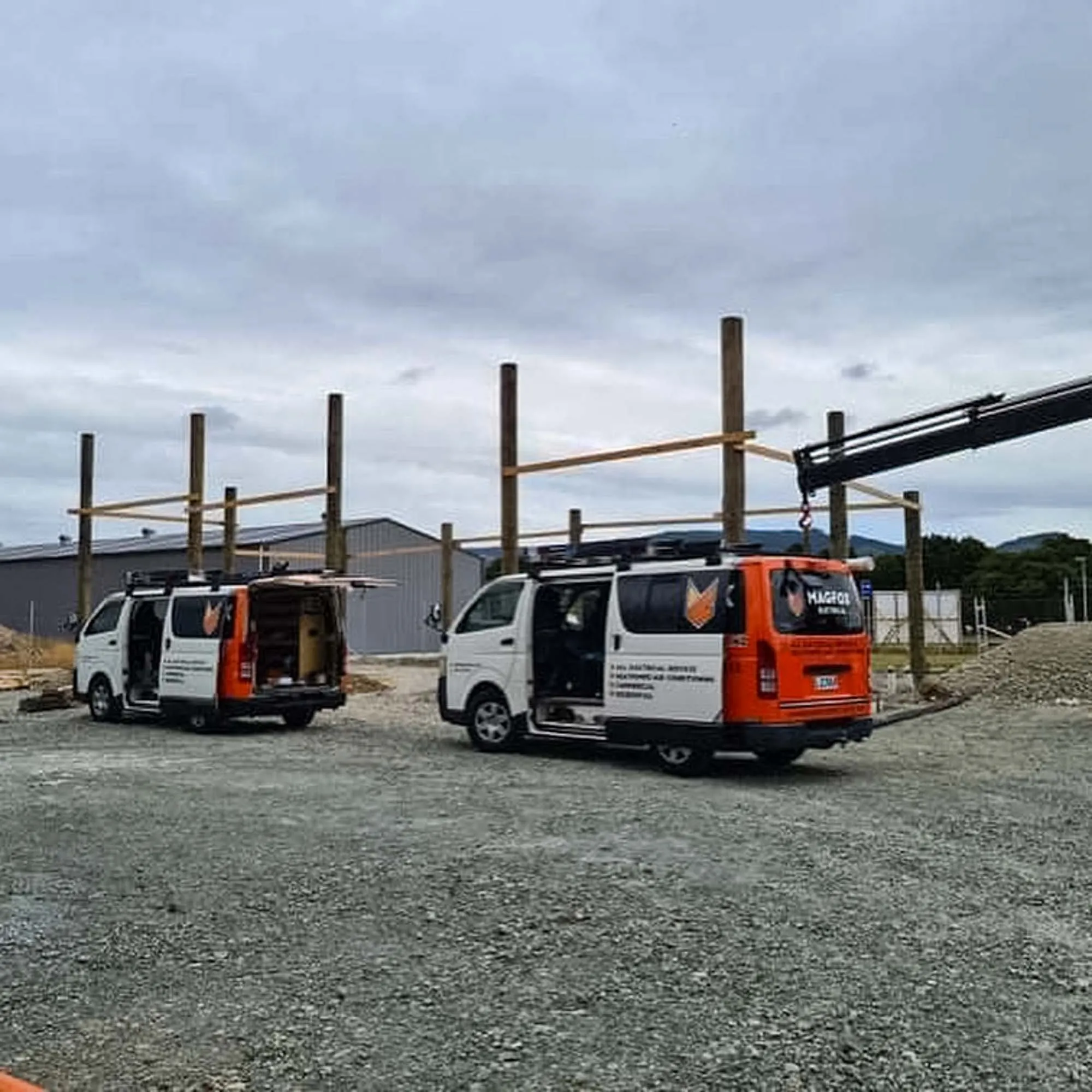 a couple of vans parked next to a crane