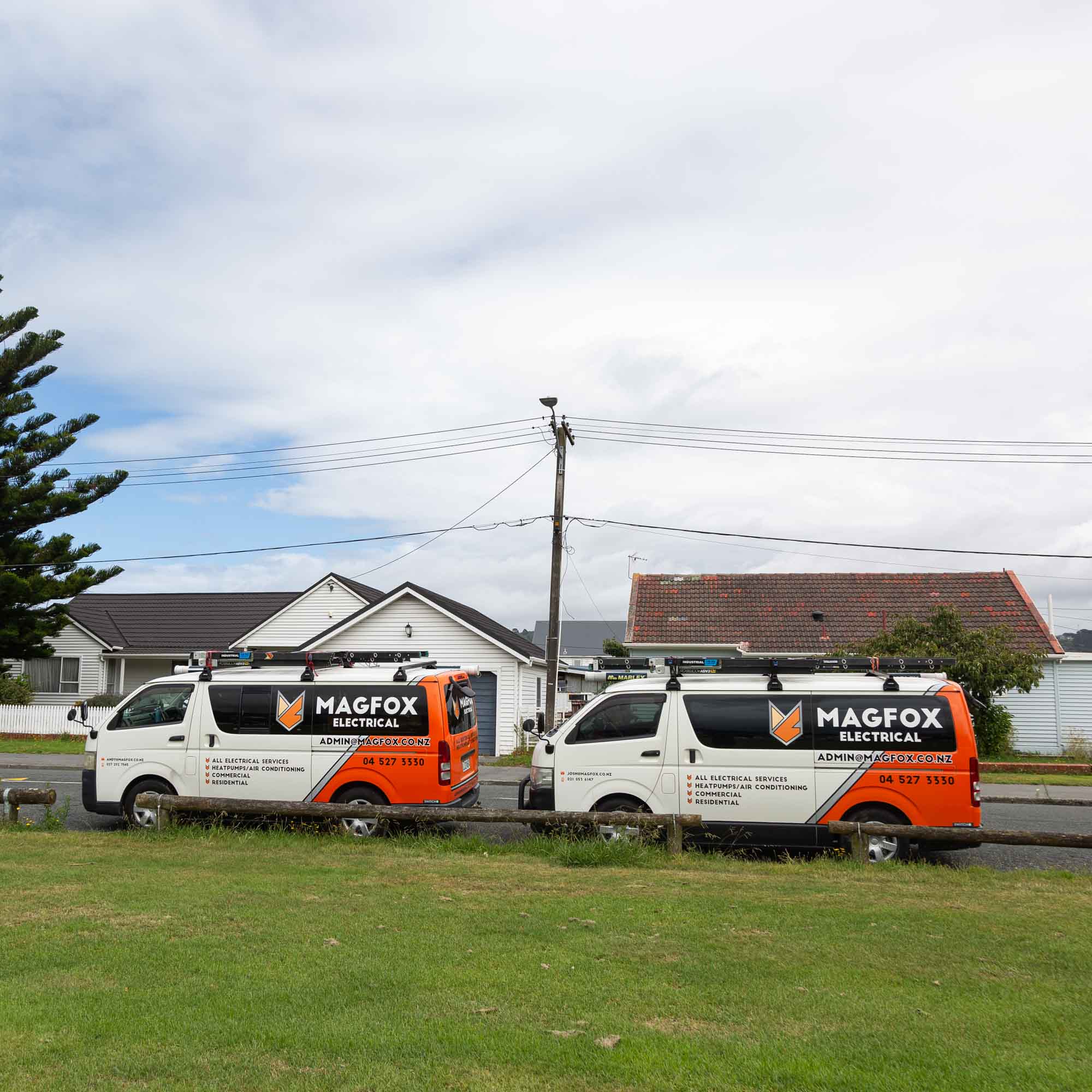a couple of white vans parked next to a building