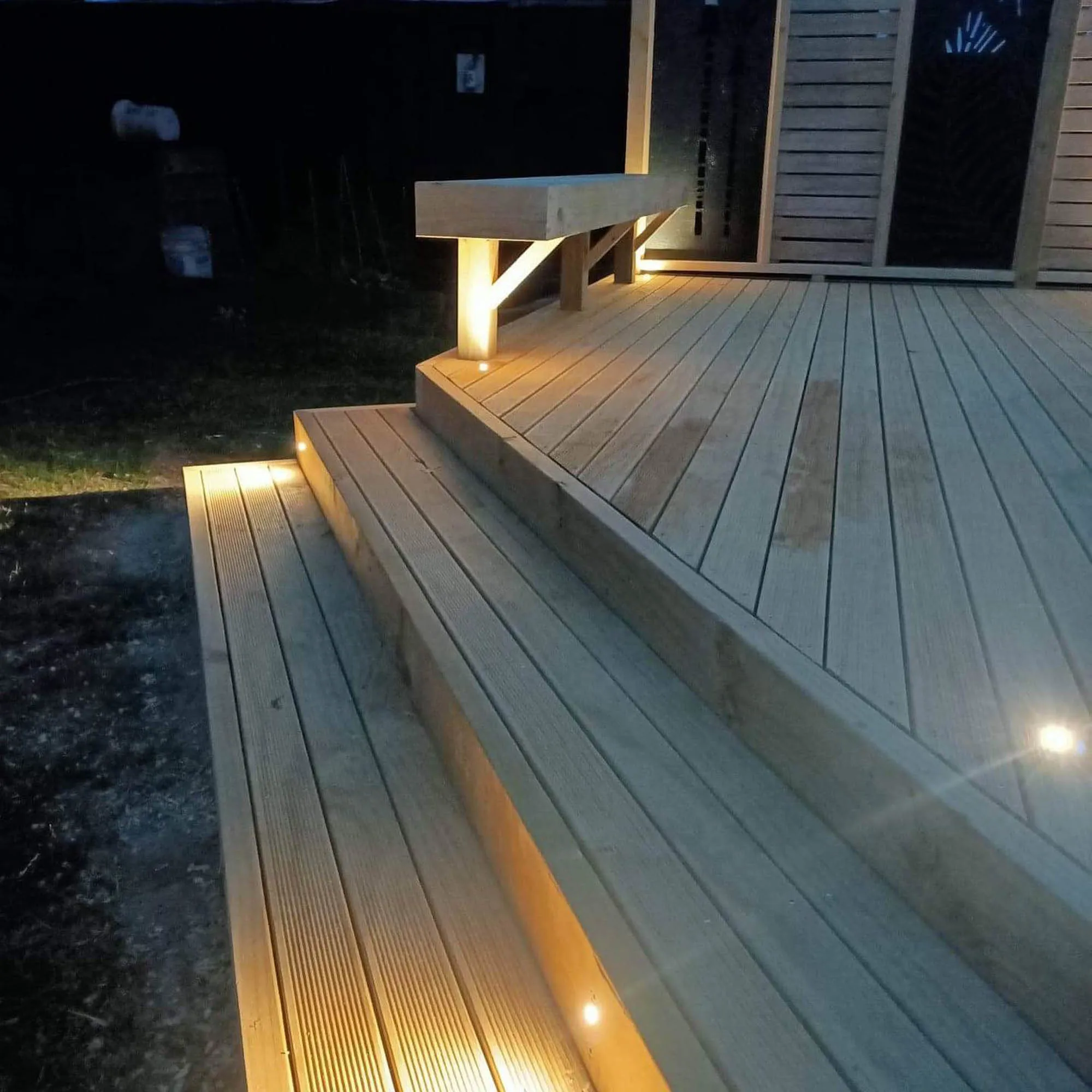a wood deck with a bench