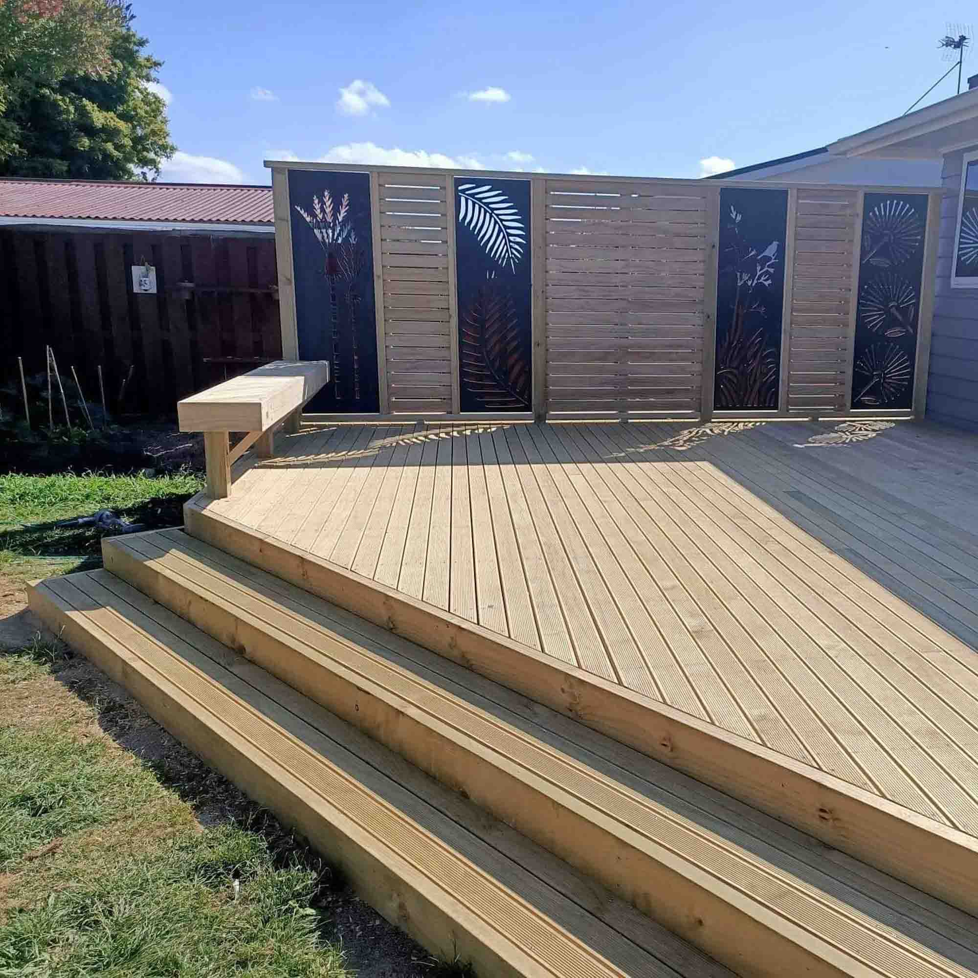 a wooden deck with a bench and a wood fence