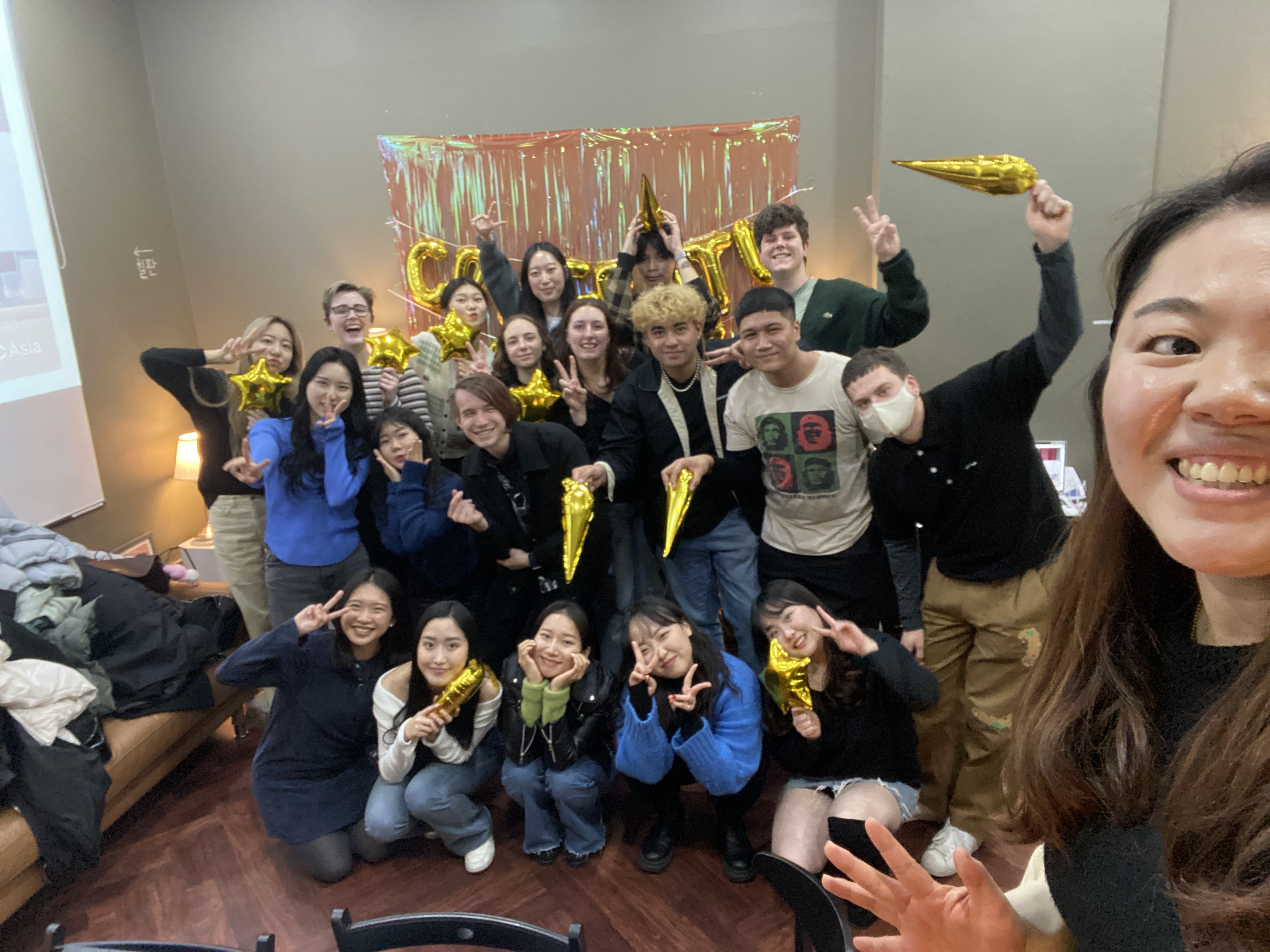Char and all fellow interns posing for a photo with balloons