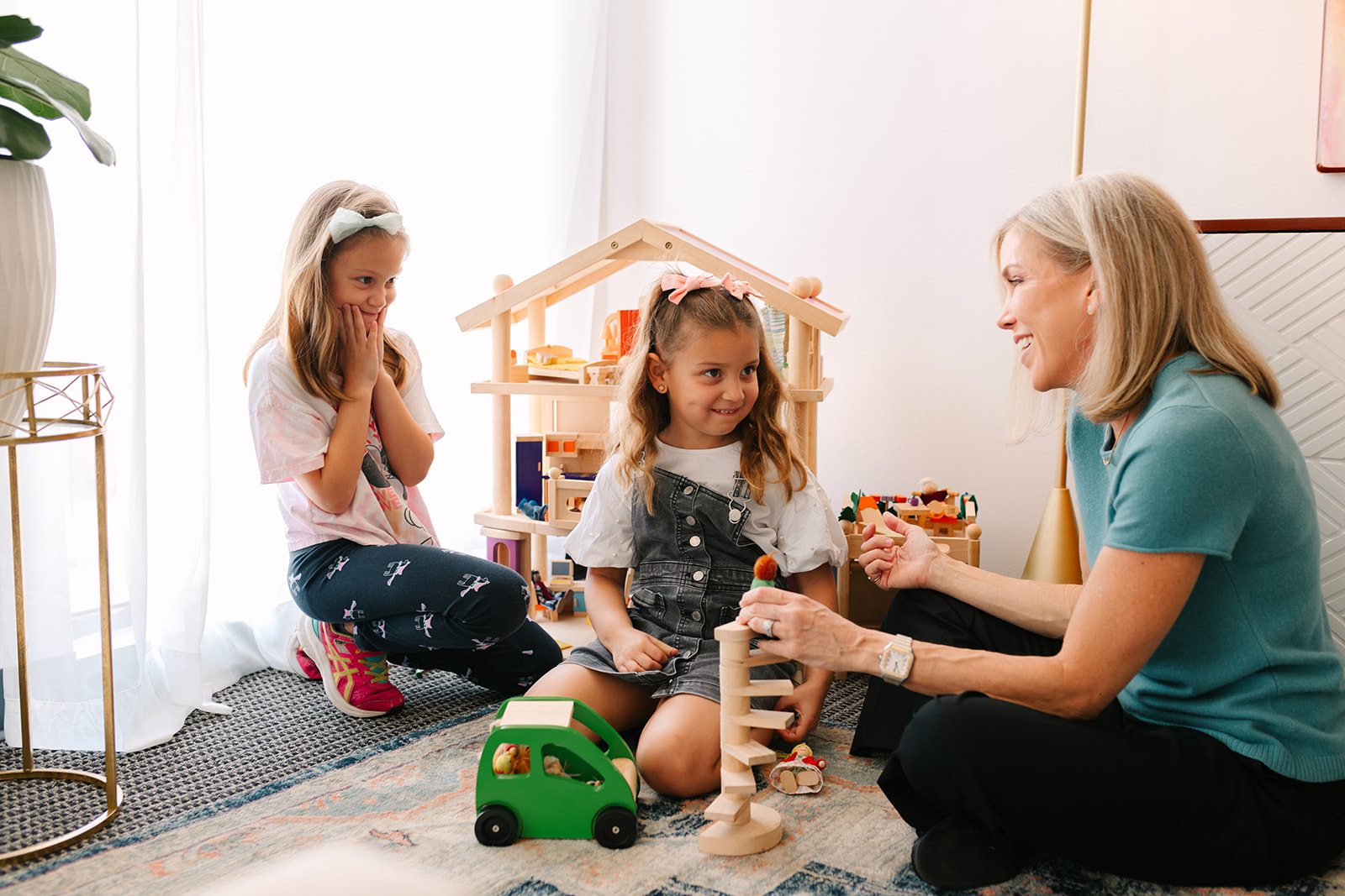 Houston therapy play therapy with a child and therapist using a dollhouse to support emotional expression.