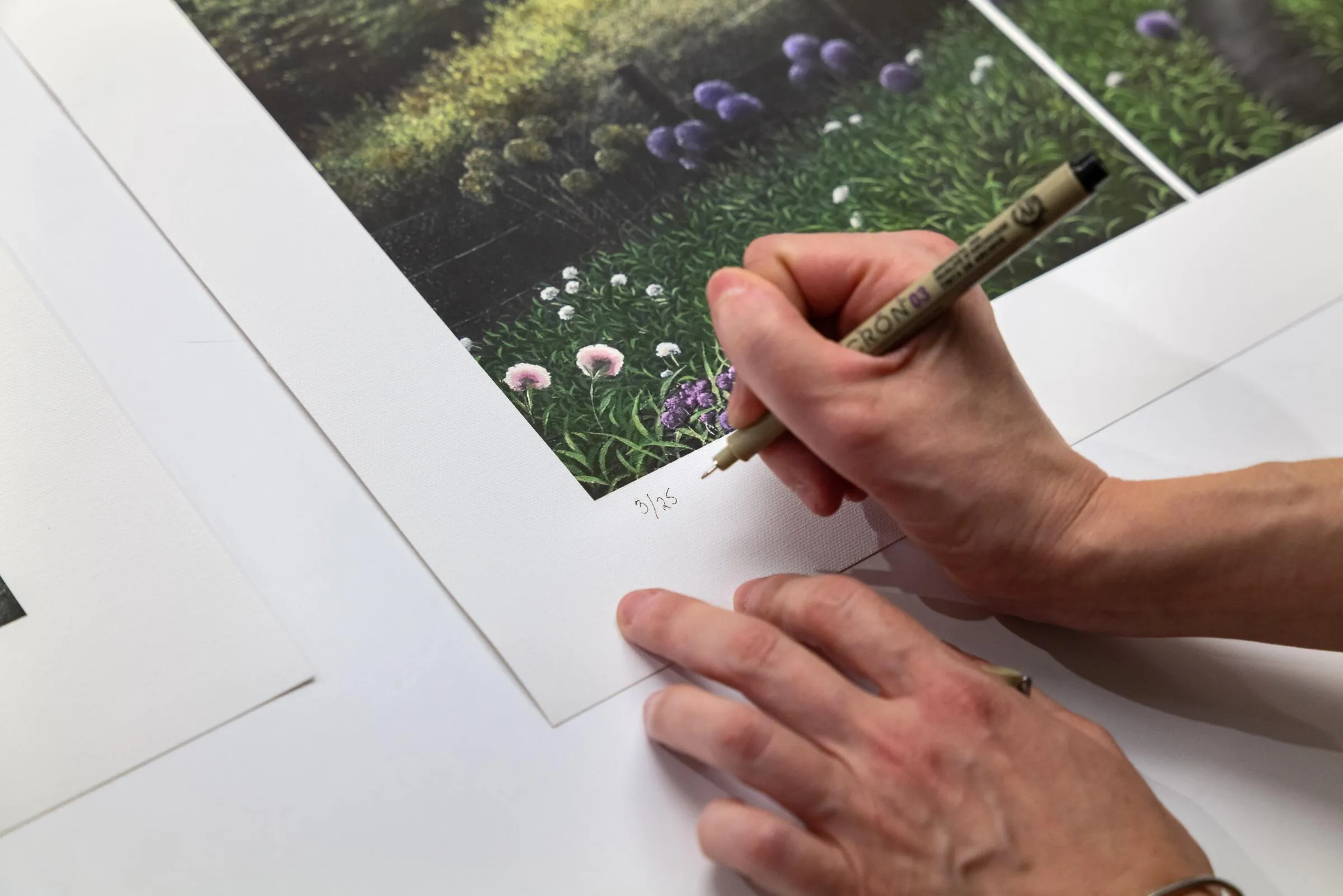 Artist Fulfillment Servies, photo of artist hand signing artwork