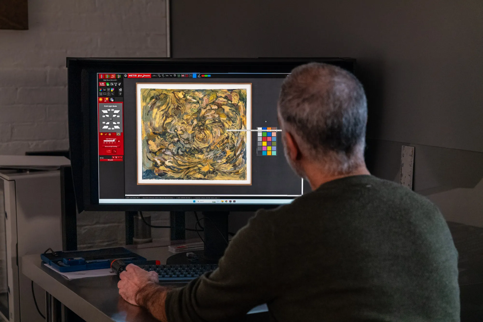 Brooklyn Editions reviewing a scan file on color-calibrated monitor