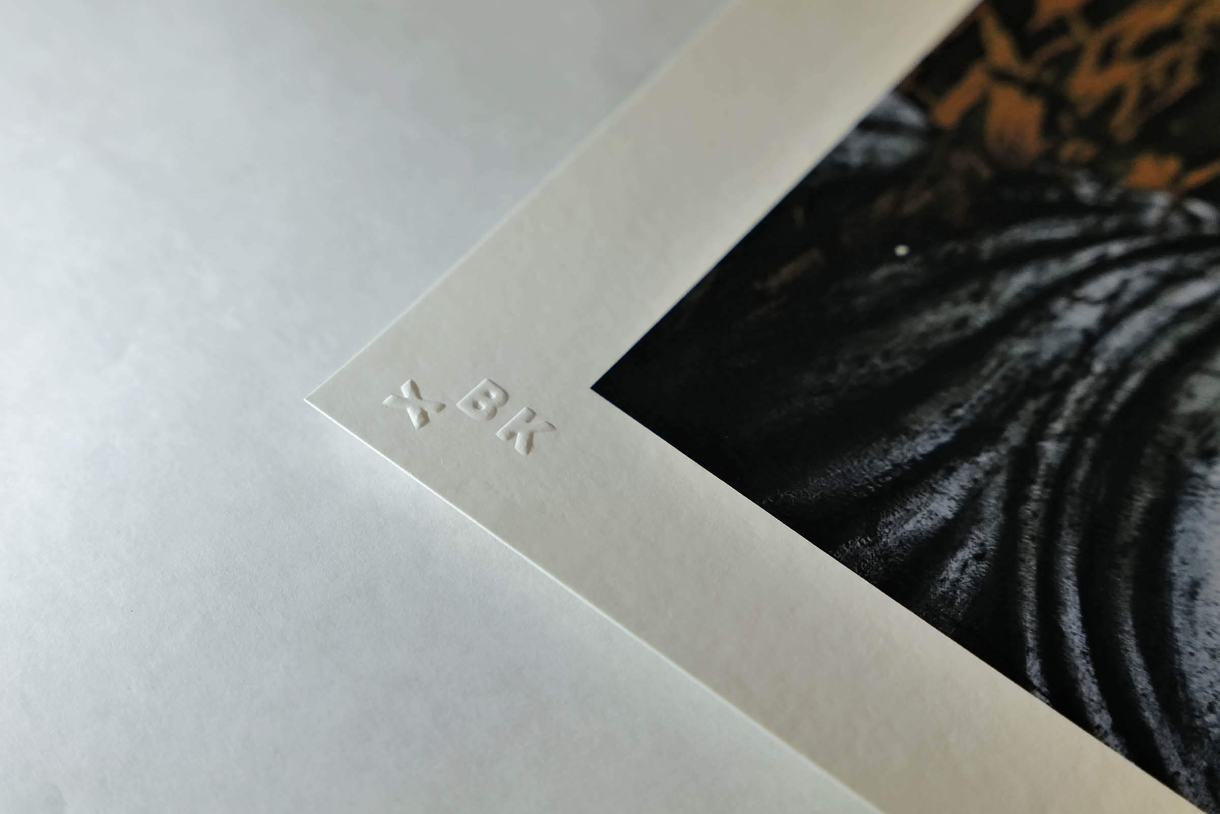Detail photograph of the BKX printer's stamp embossing on the edge of an archival inkjet print