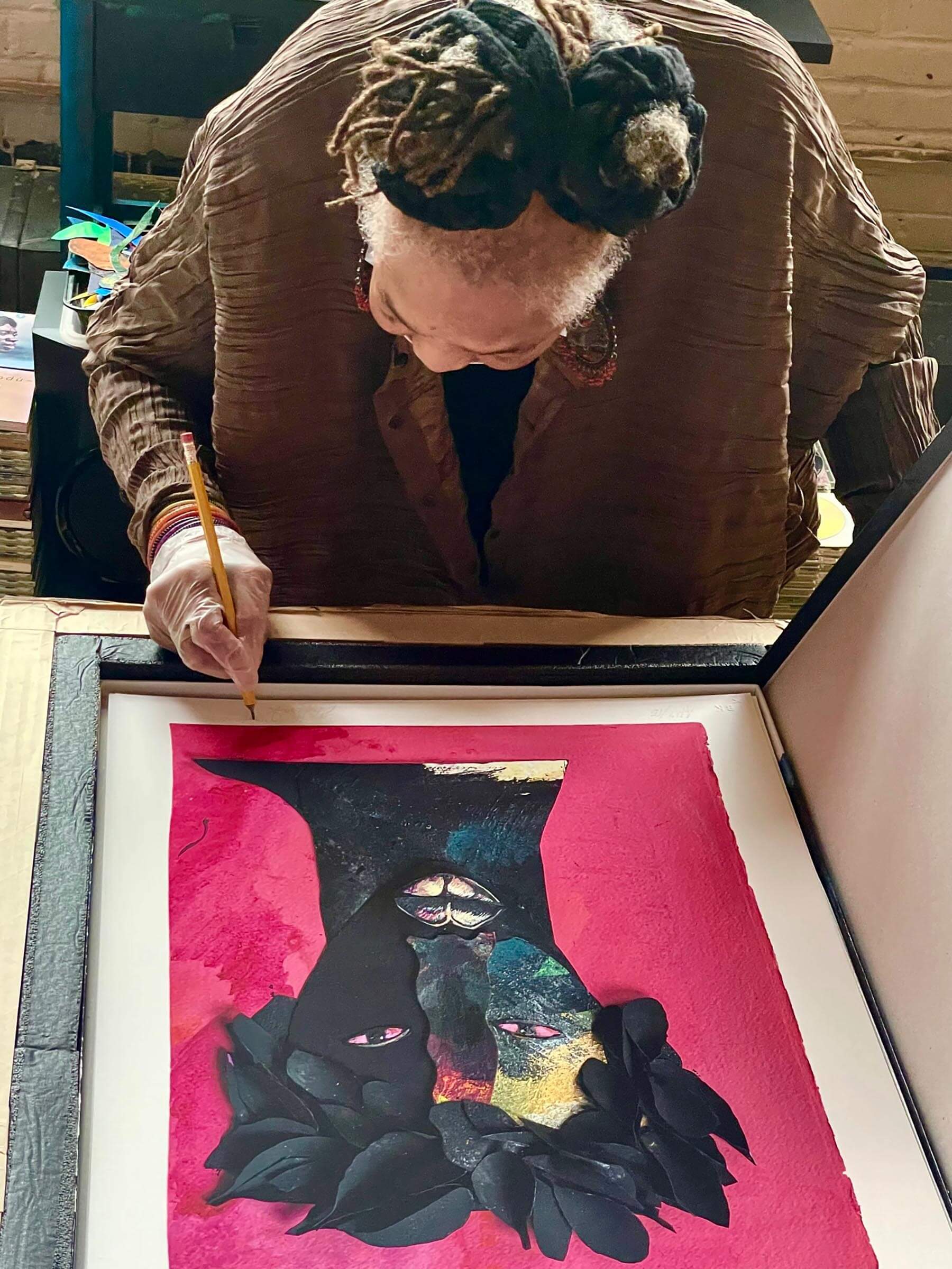 Barbara Bullock signing a copy of her print 'Timbuktu' in her studio