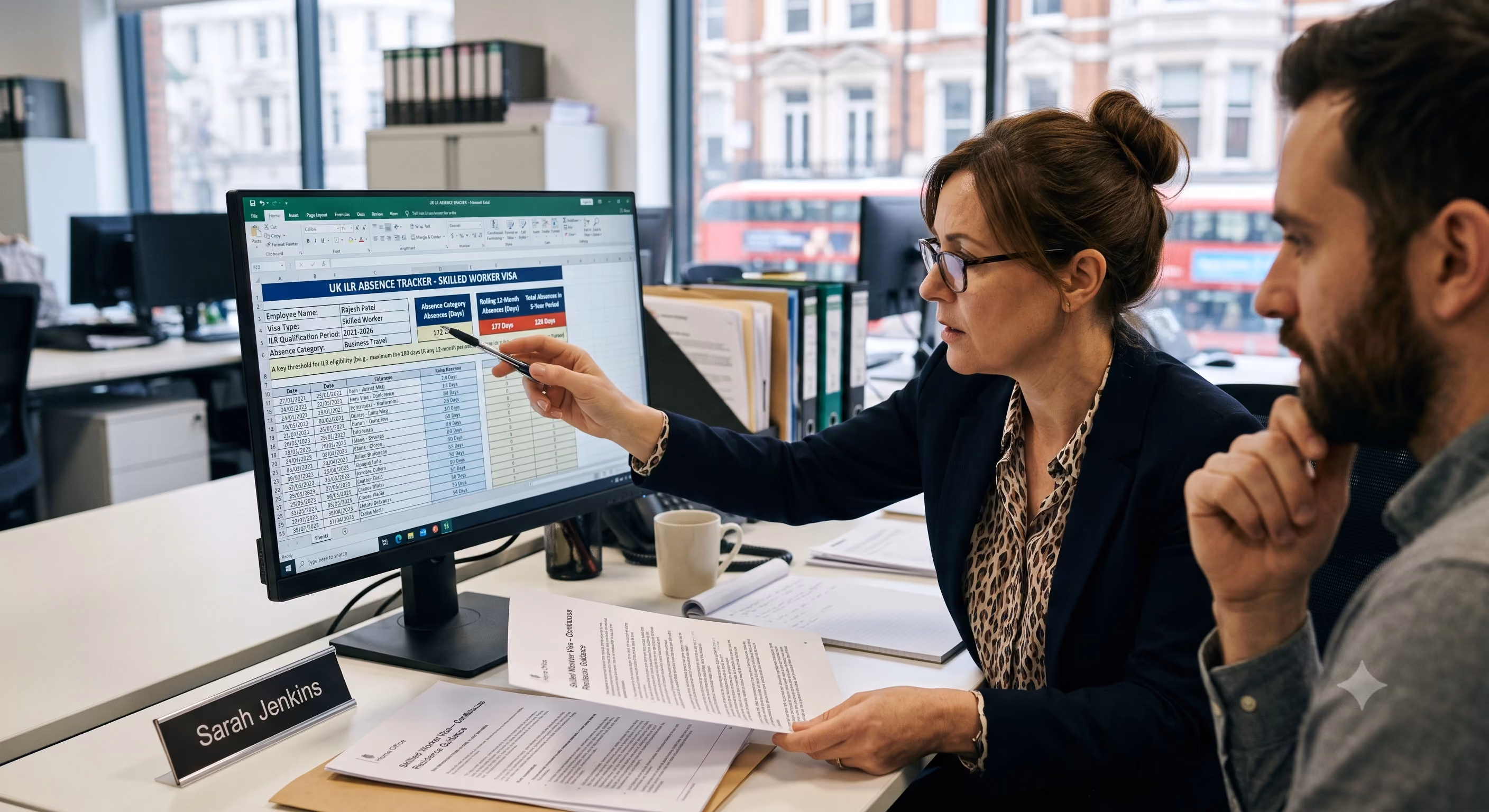 HR manager reviewing UK ILR absence tracker showing rolling 12-month business travel days for a sponsored Skilled Worker visa employee