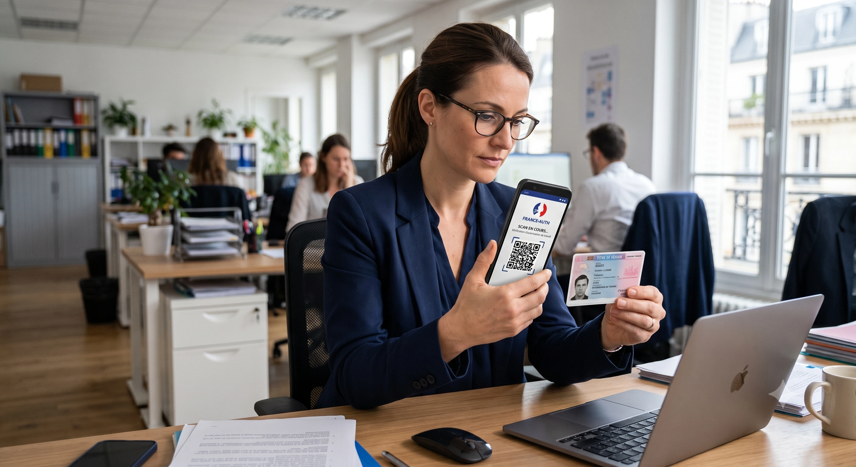 HR manager scanning a French residence permit QR code with the France-Auth app to verify work authorisation
