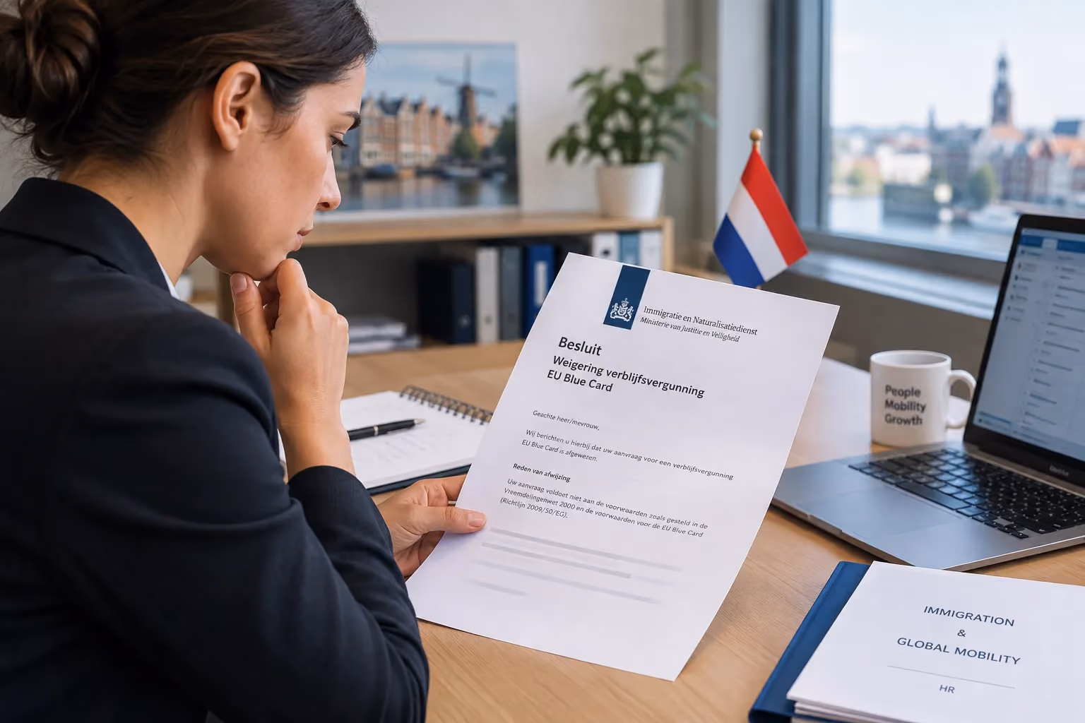 HR manager reviewing an IND EU Blue Card refusal letter in the Netherlands