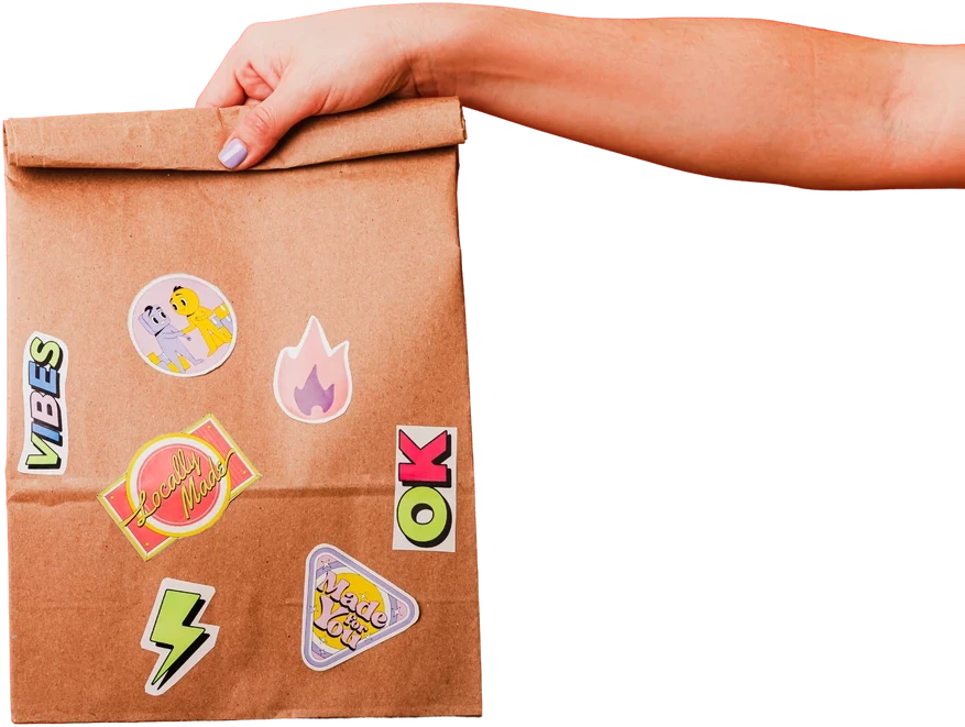 A hand carrying a sticker-covered lunch bag, from the School Food Innovation Report