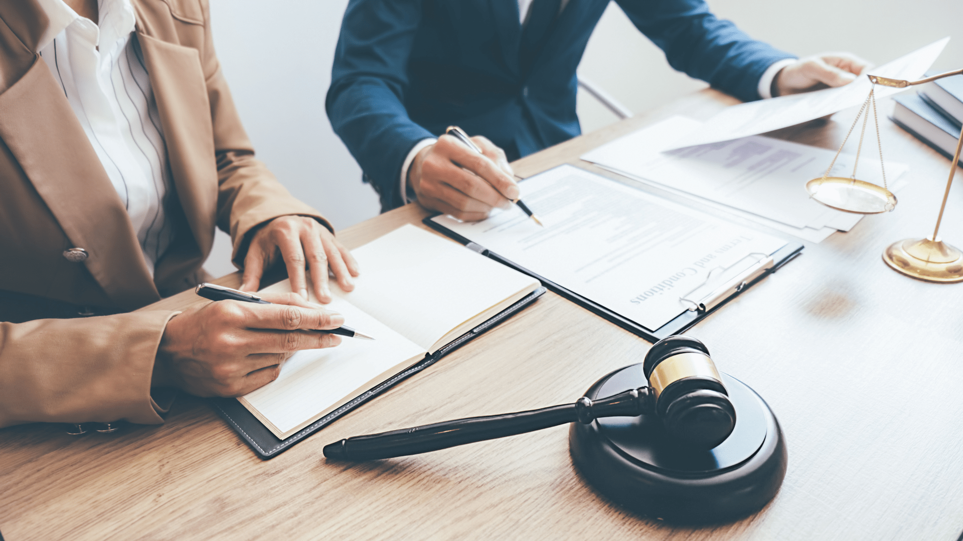 A pedestrian injury lawyer discussing a case with a client.