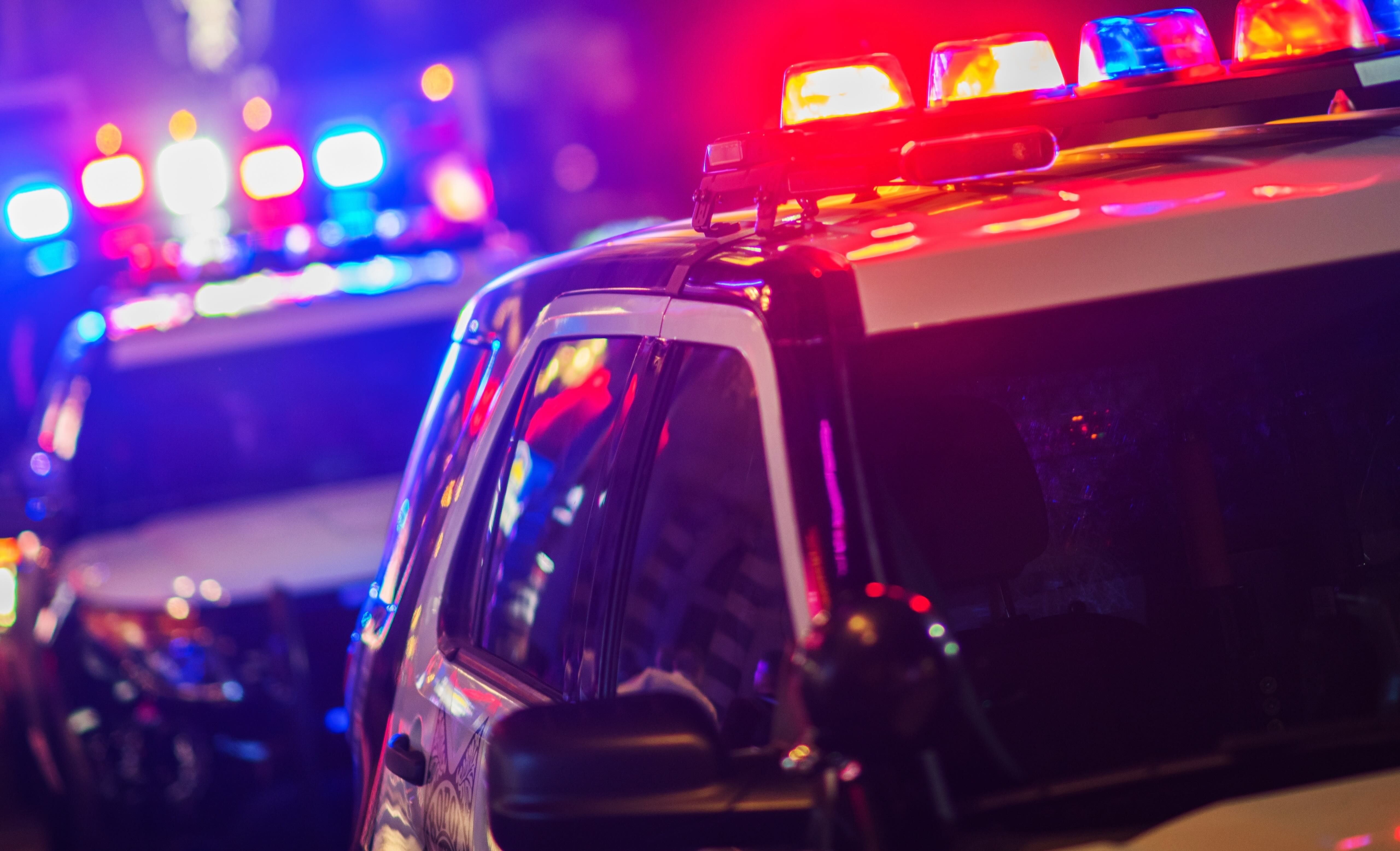Police car lights flashing at night., image