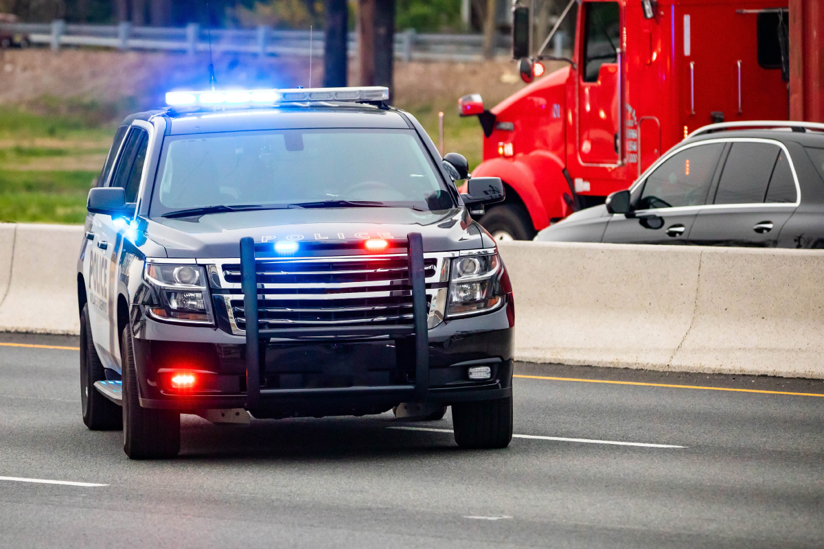 Police SUV sitting in the road with its lights on