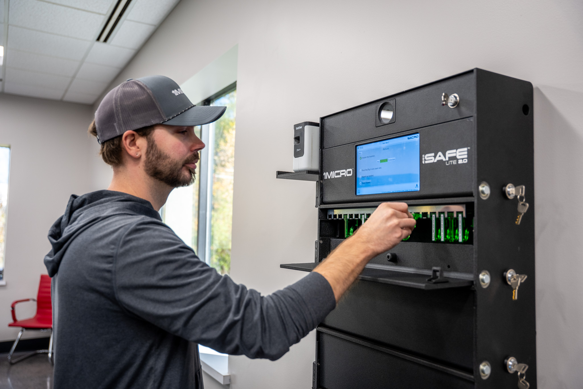 Man returning KeyTag to iSafe Lite mounted on white wall