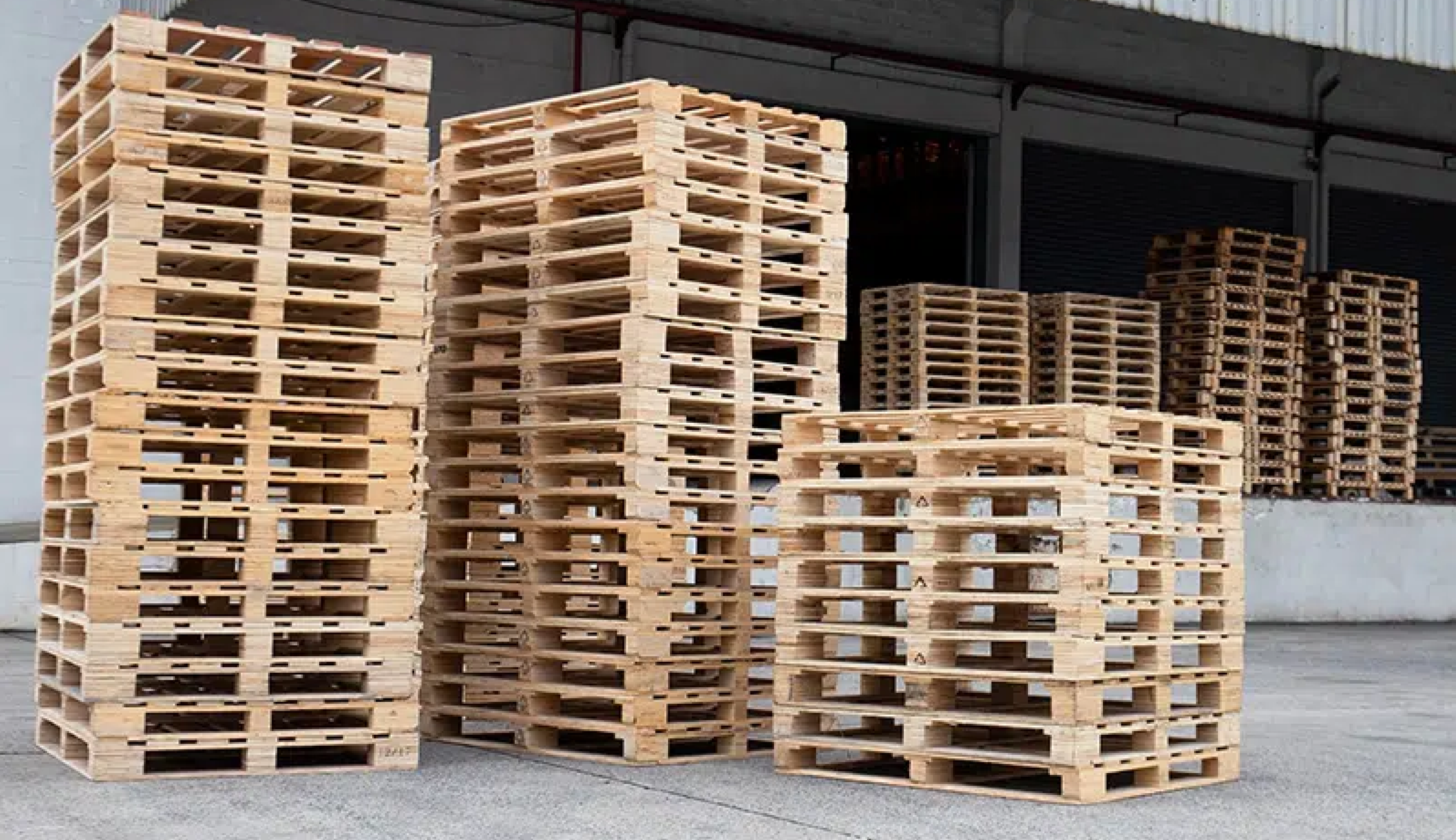 Pallets staged beside a warehouse loading bay