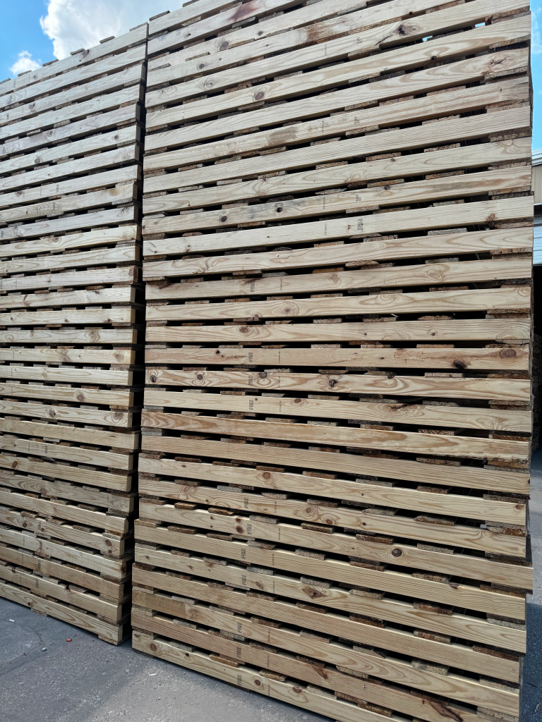 Tall stacks of custom sized wooden pallets