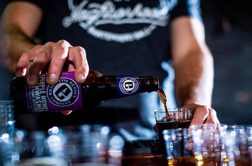 Woman poring a beer.