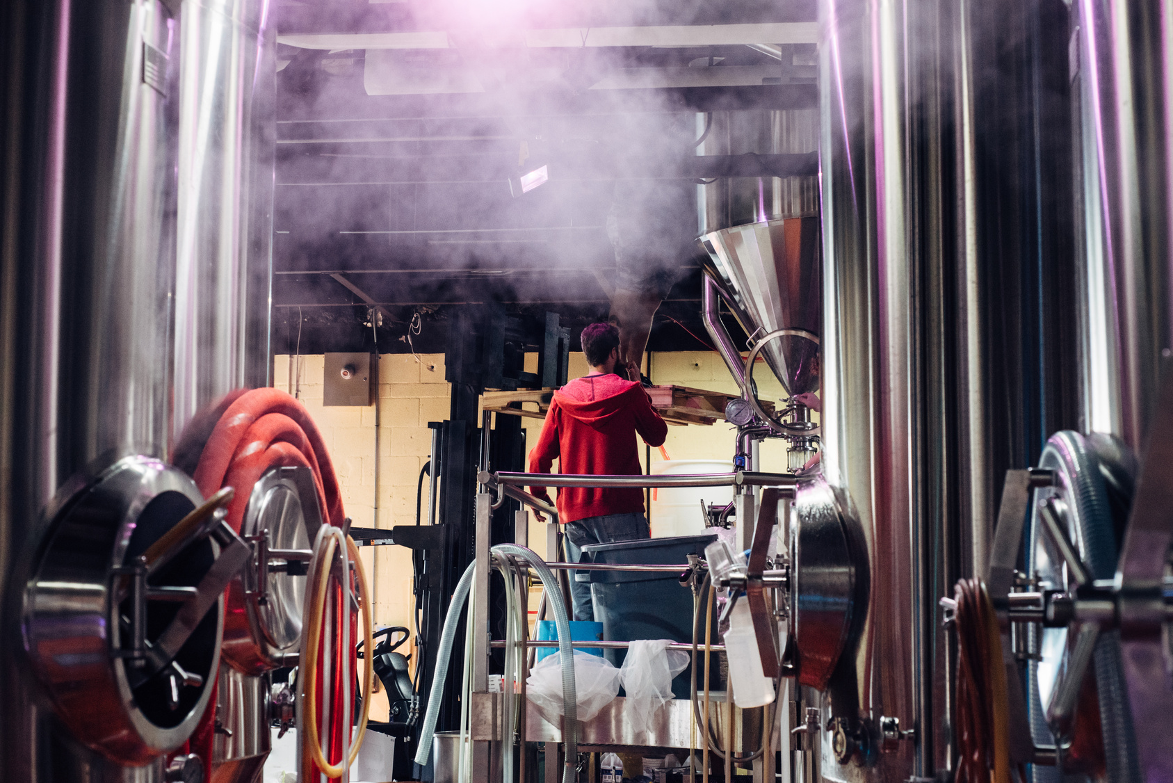 A brewery team member inspecting tank pressure at Scott Free Brewing, part of the operational foundations behind its growth.