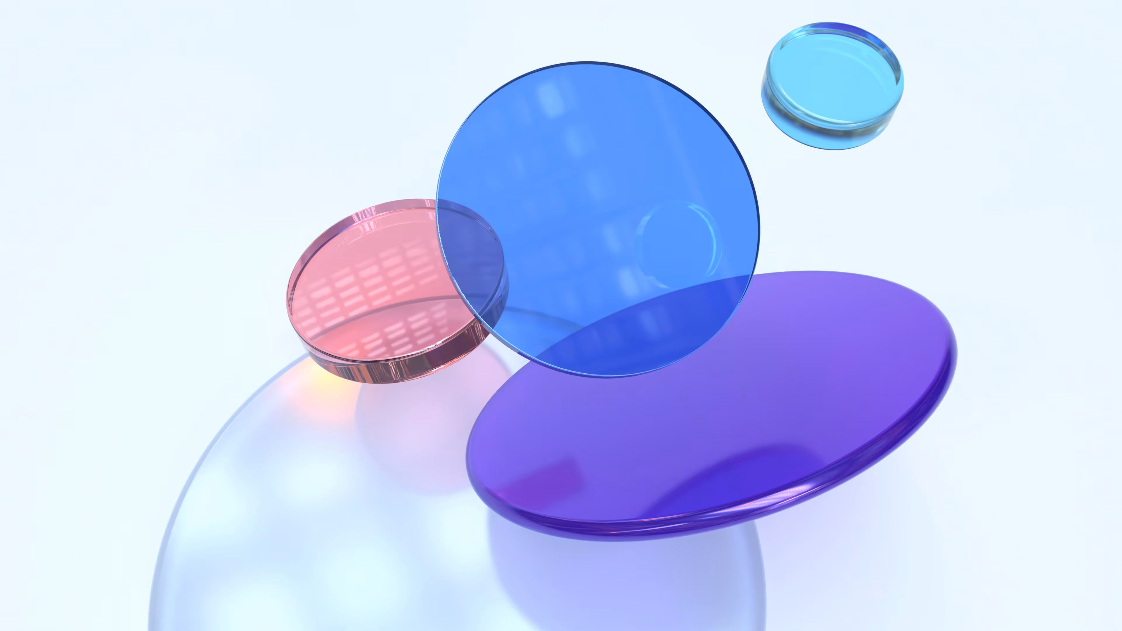 Translucent overlapping circular discs in shades of blue, purple, and pink on a light background.