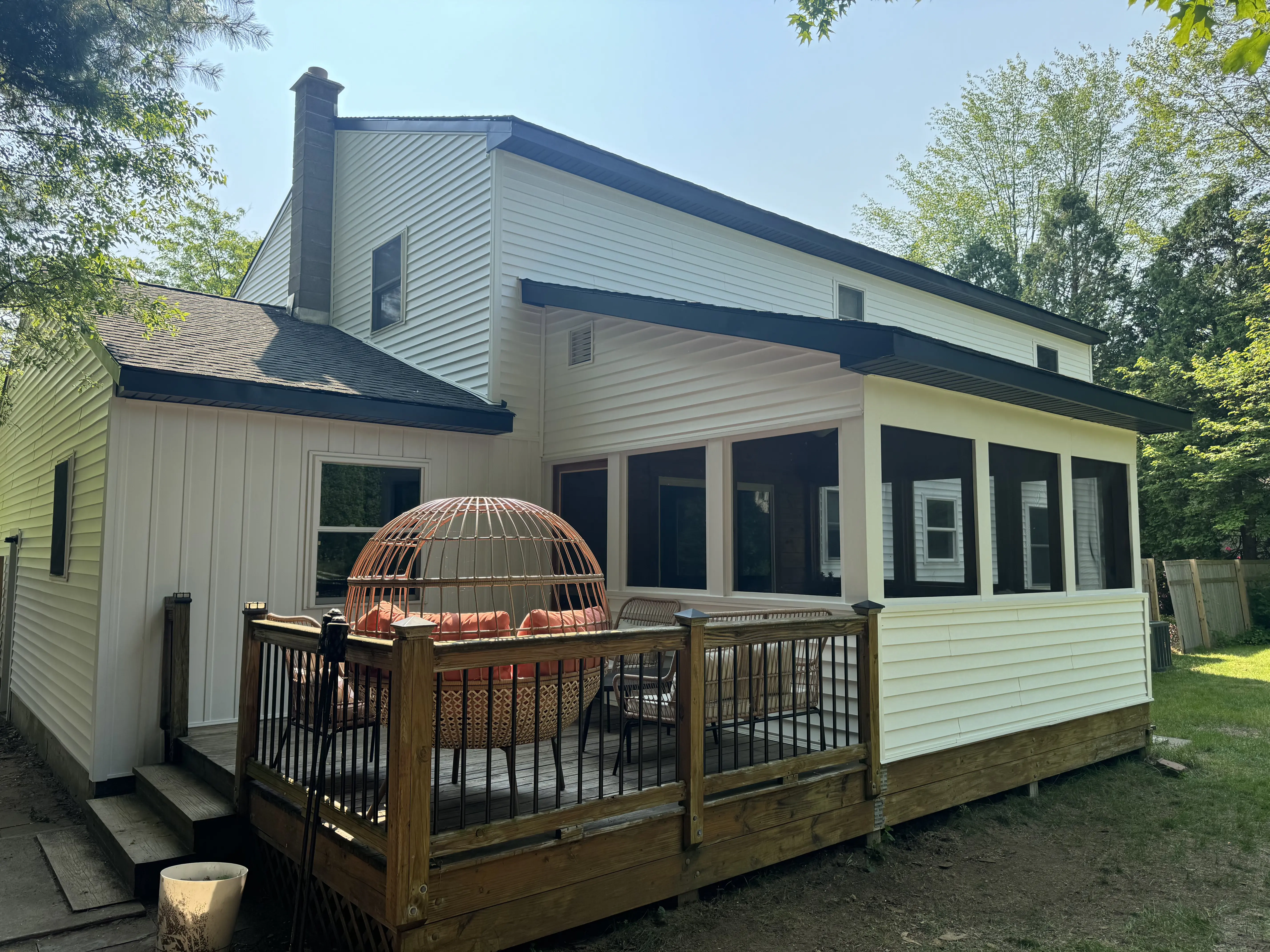 a deck with a large bird cage on it