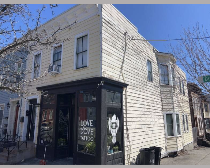 Worn siding and trim on an older home before exterior renovation