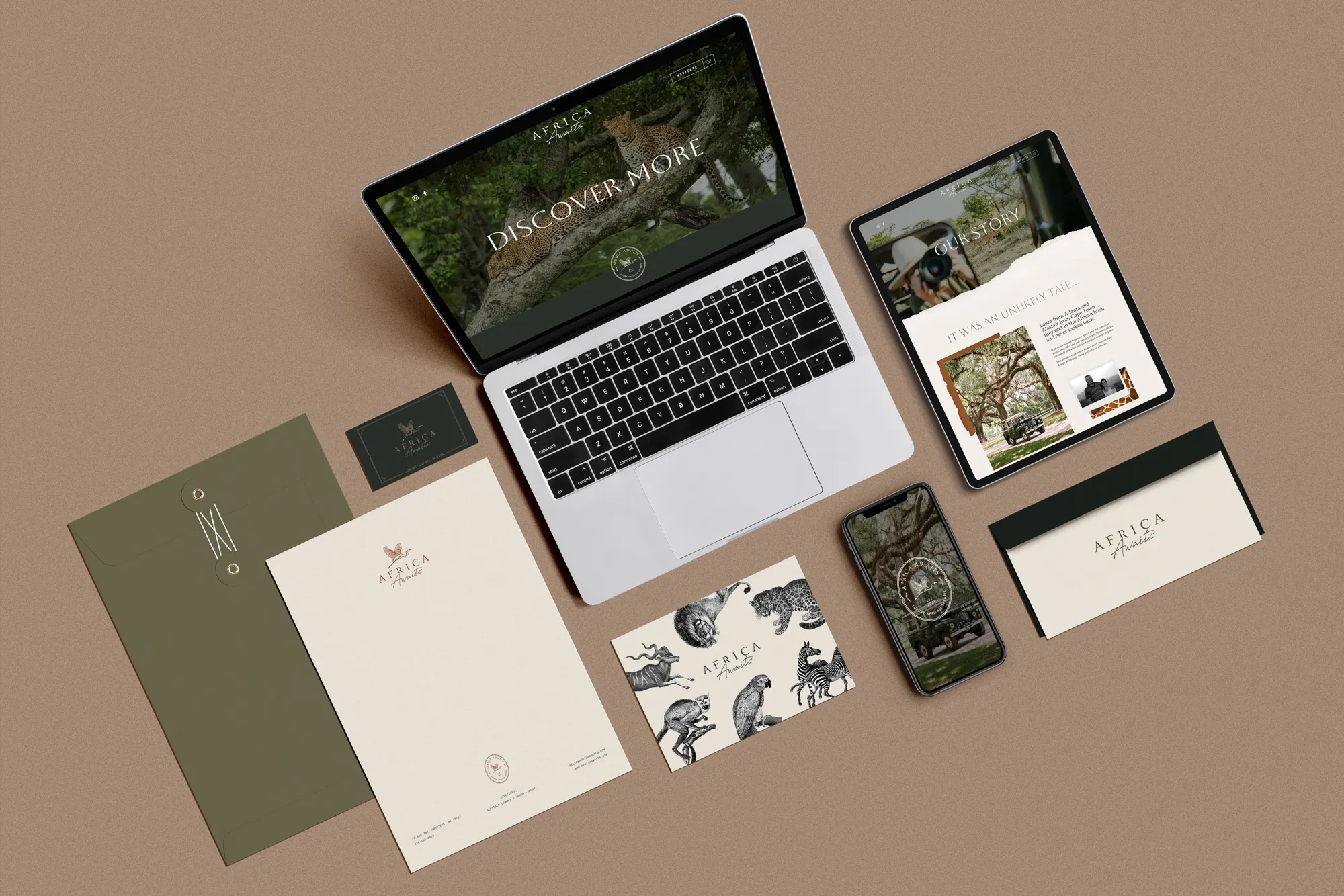 Flat lay of digital and print branding materials for Africa Awaits, including a laptop, tablet, smartphone, business card, envelope, letterhead, and illustrated postcard featuring African wildlife.