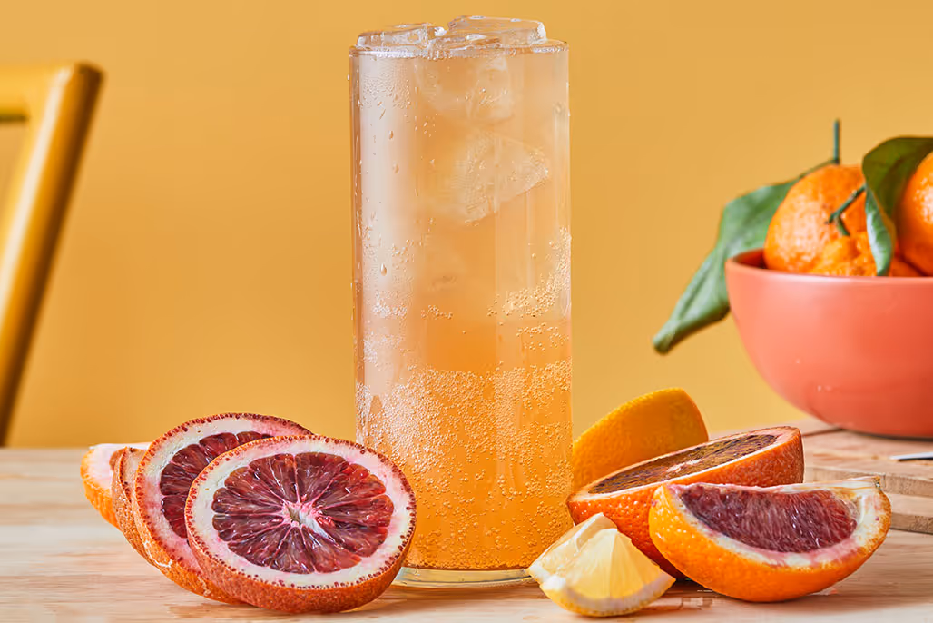 Brew Dr. Blood Orange Kombucha poured into a tall glass