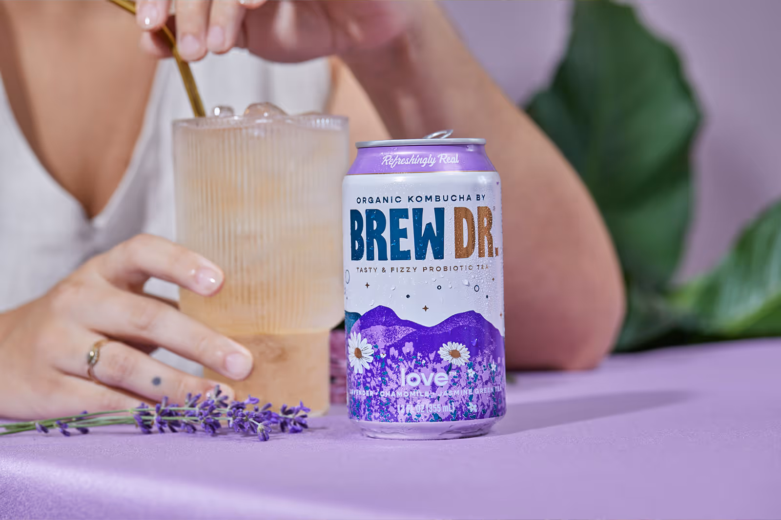 A person drinking Brew Dr. Love kombucha
