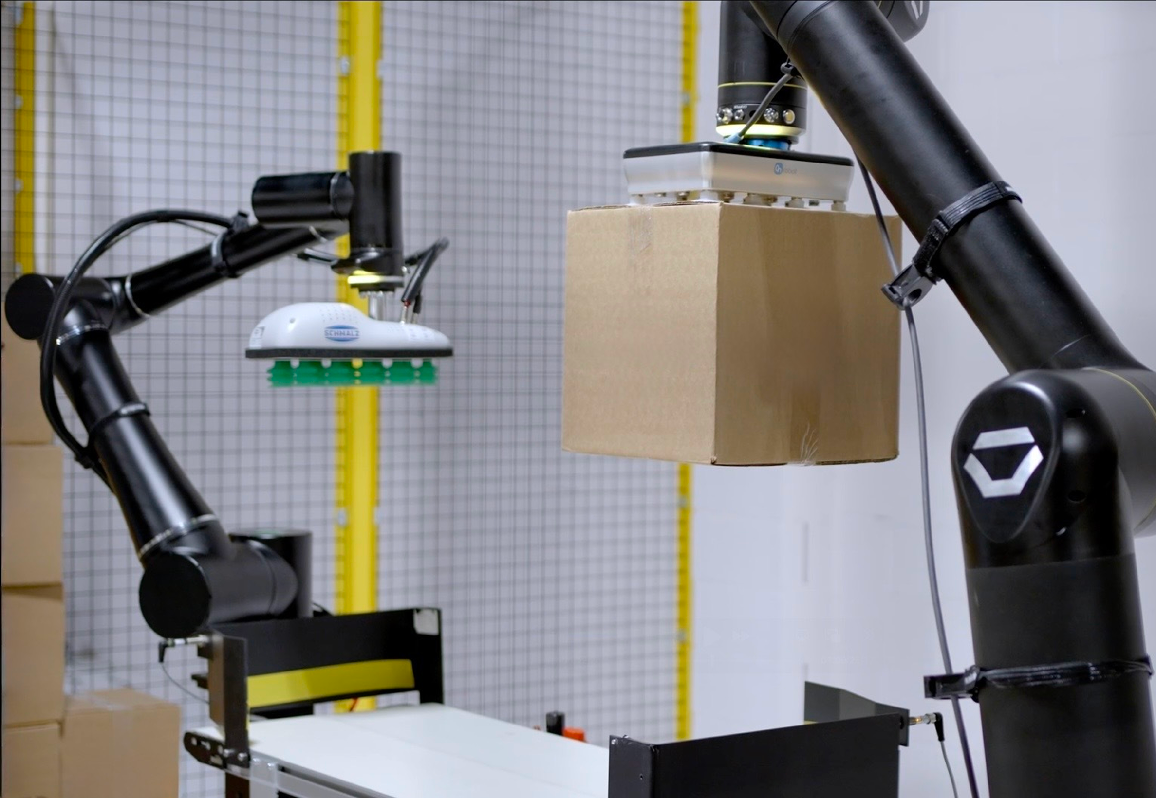 2 standardbot robots stacking boxes