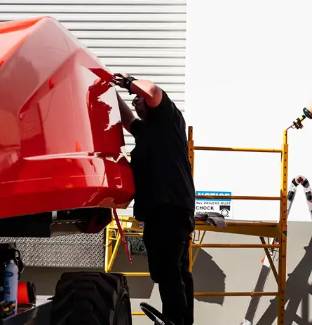 Car wrapping expert working on large truck