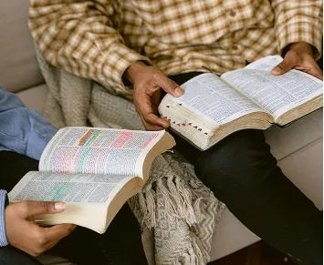 Two people reading bible passages