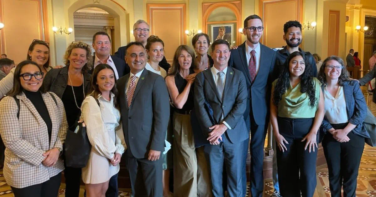 Persefoni Chief Decarbonization Officer Mike Wallace and EVP Russ Mitchell, with bill sponsors and SB 253 author Sen. Scott Wiener, outside the Assembly chamber following the 49-20 vote.