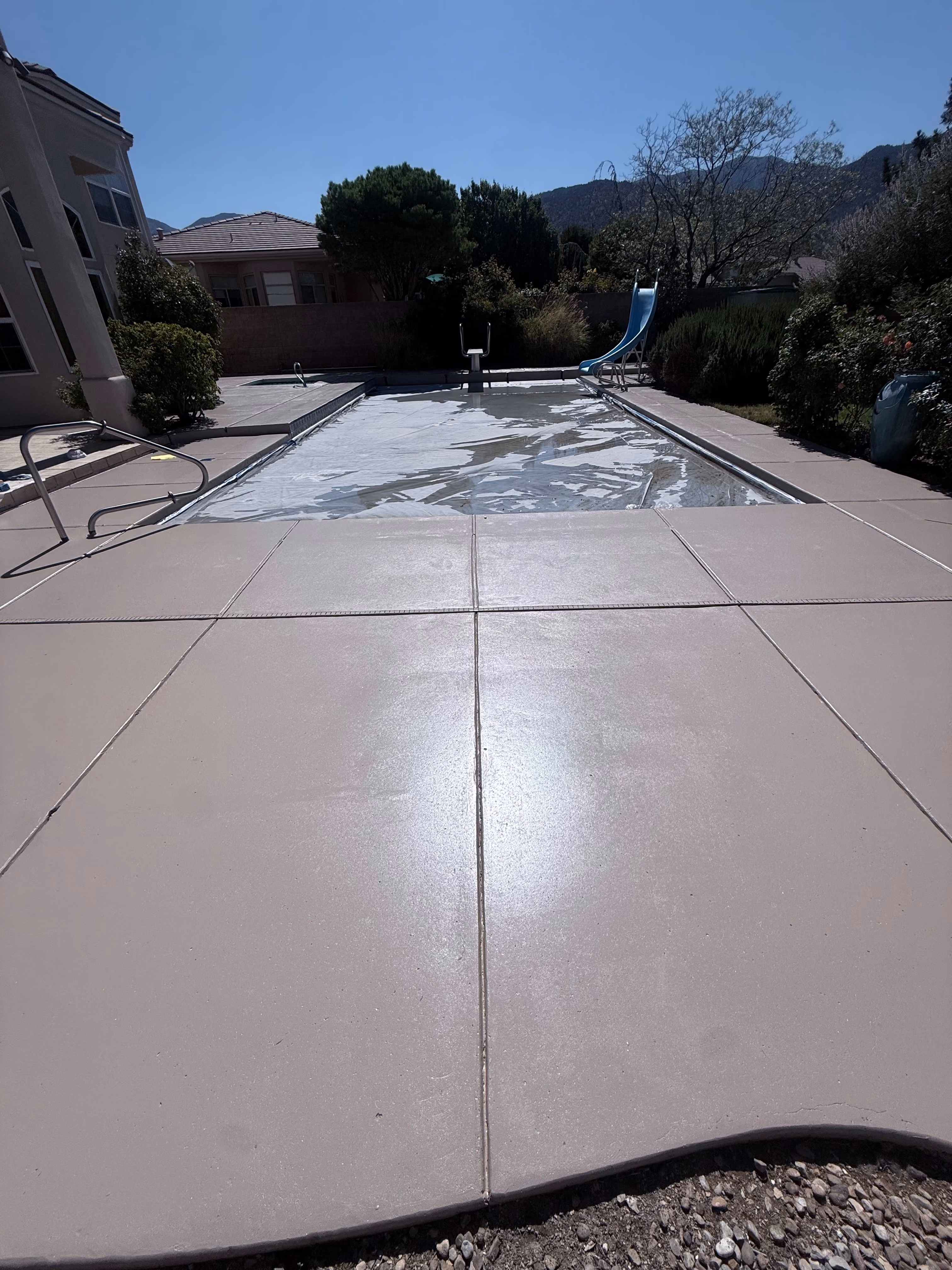 Concrete pool deck refinished and resurfaced.