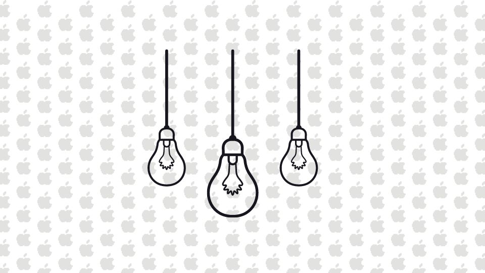 3 dangling light bulbs with a background of multiple Apple logos