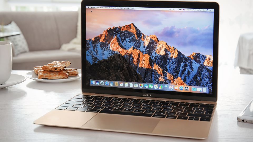 A macbook desktop with pastries and a white background.