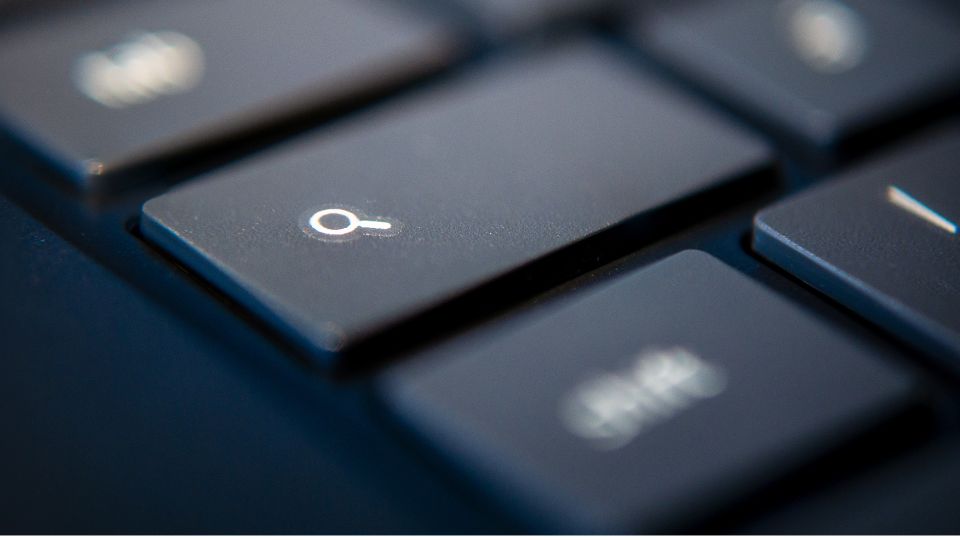 A zoomed in angle of a magnifying glass button on a keyboard.