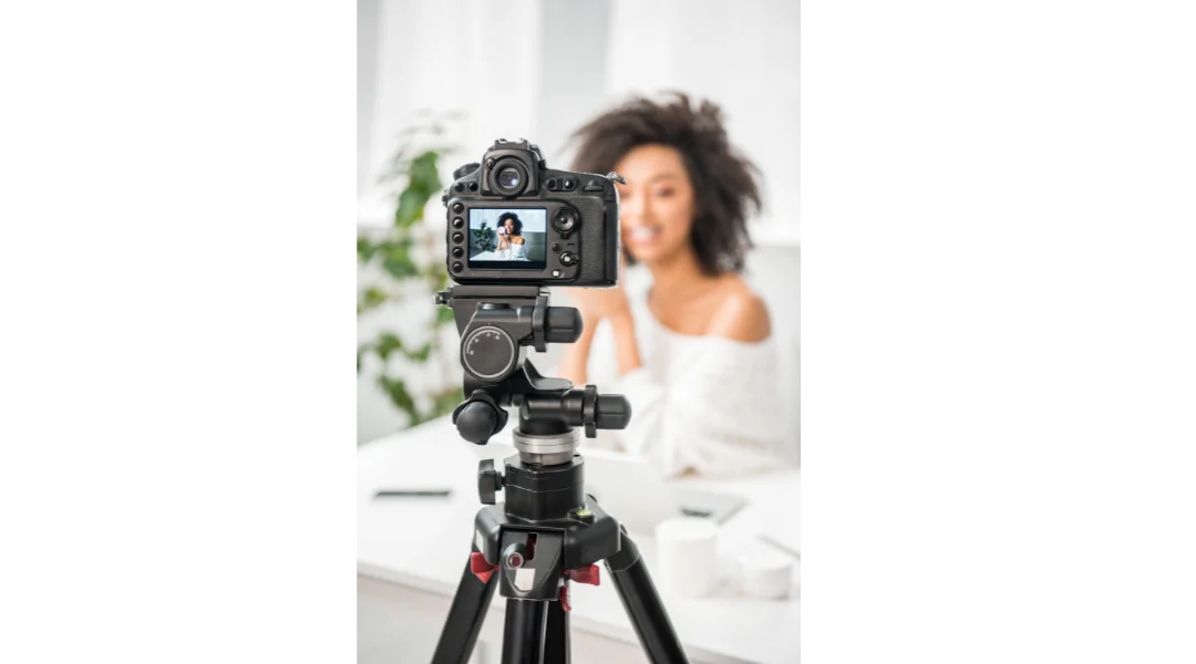 A woman recording herself on a tripod