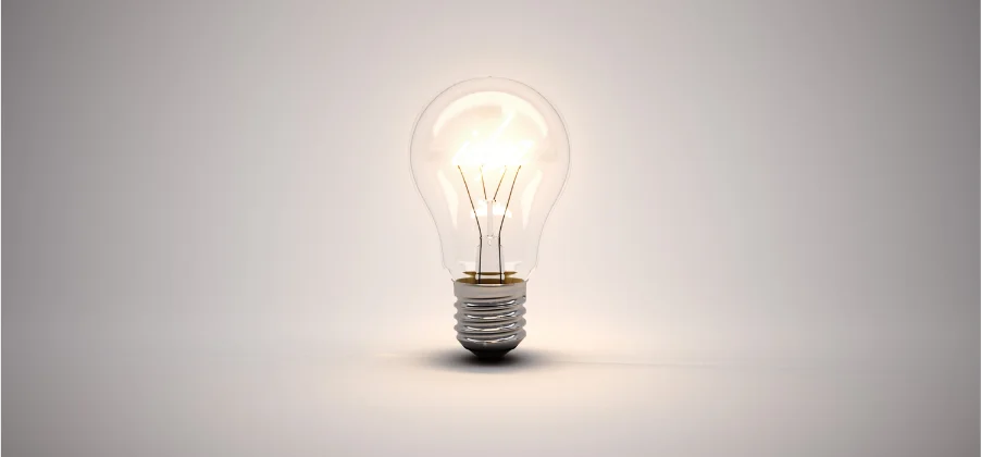 A light bulb lit with a soft white color