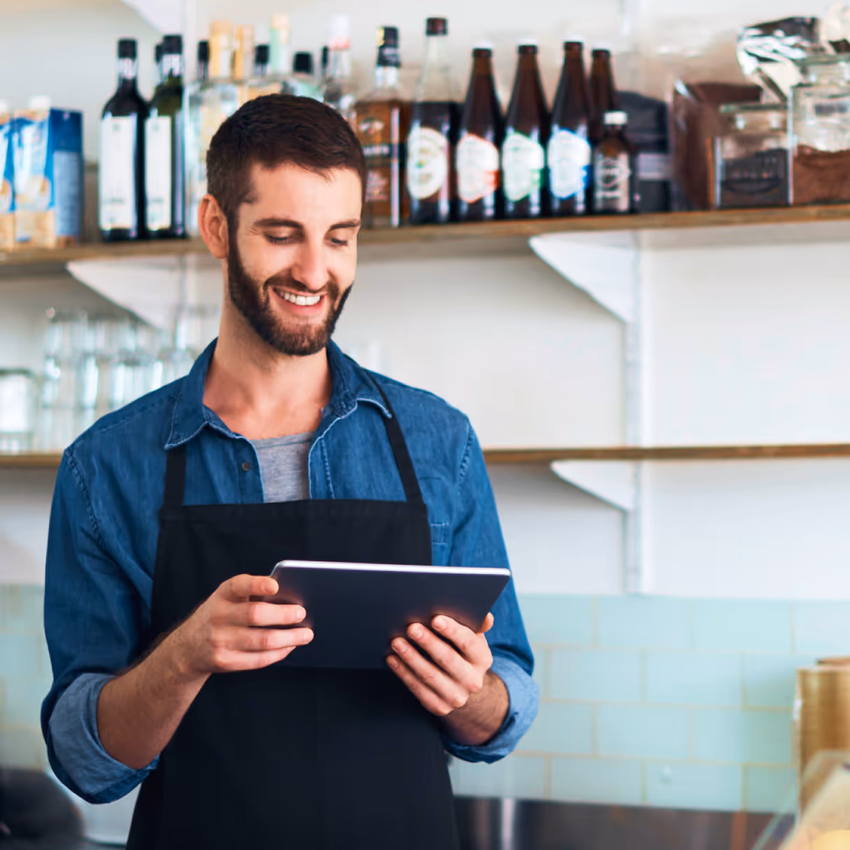 a barista holding a tablet